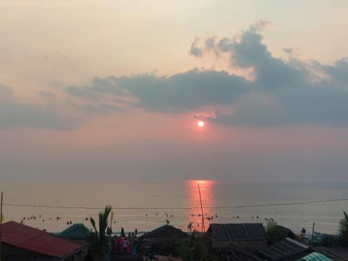 a sunset over the ocean with the sun in the sky at Kua's Pad Batangas Tent in Calatagan