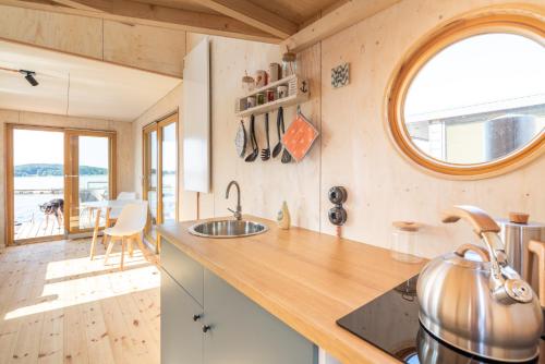 a kitchen with a counter and a sink in a room at Hausboot Helena in Schleswig