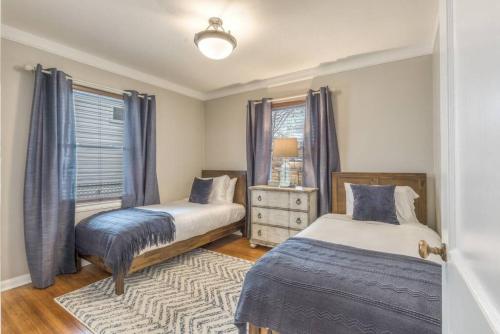 a bedroom with two beds and a window at OneCozyPlace Tulsa - King Bed Expo, TU, Downtown in Tulsa
