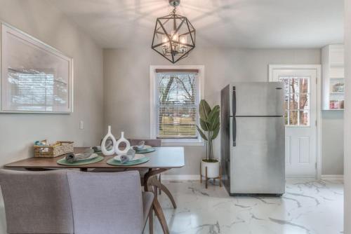 a dining room with a table and a refrigerator at OneCozyPlace Tulsa - King Bed Expo, TU, Downtown in Tulsa