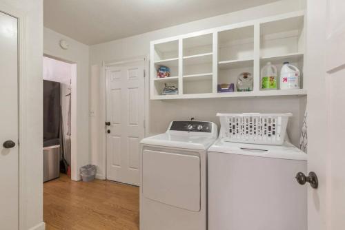 a white laundry room with a washer and dryer at Tulsa Home Sweet Home - King Bed Near Expo, TU, Dtwn in Tulsa