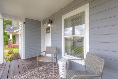 a porch with two chairs and a table and a window at Tulsa Boho Bungalow - King Bed Near Dtwn, EXPO, TU in Tulsa