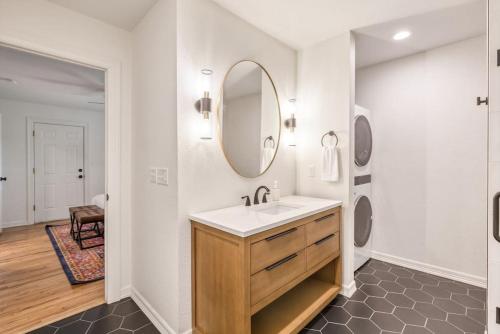 a bathroom with a sink and a mirror at Trendy in Tulsa - King Bed Expo, TU, Downtown in Tulsa