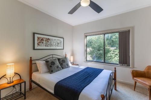 a bedroom with a bed and a window at La Casa in Myrtleford