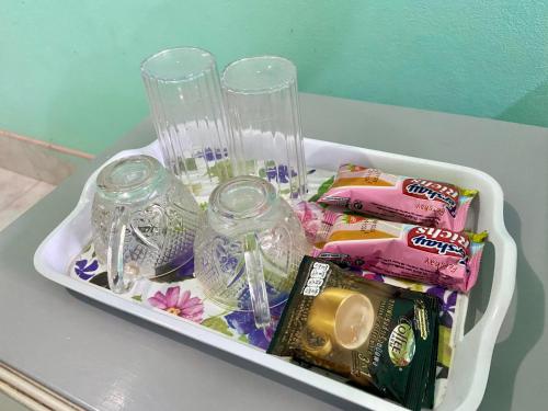 um recipiente cheio de doces e frascos de vidro vazios em Thungtako Resort em Ban Samnak Pling