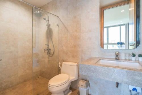 a bathroom with a shower and a toilet and a sink at Marbella Beachfront Pattaya 3BR in Bang Lamung