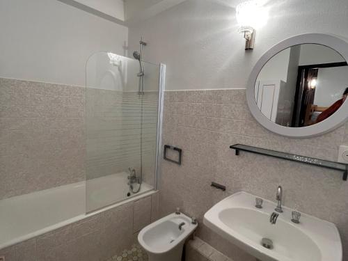 a bathroom with a sink and a toilet and a mirror at Appartement Villard-de-Lans, 2 pièces, 6 personnes - FR-1-761-34 in Villard-de-Lans