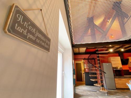 a sign hanging on the wall of a building at Loft industriel avec Spa, Sauna et Hammam en Touraine – Jardin clos et équipements haut de gamme - FR-1-381-559 in Marigny-Marmande