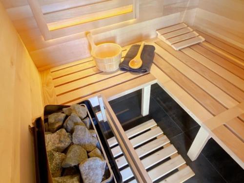 a small room with a sauna with a wooden floor at Loft industriel avec Spa, Sauna et Hammam en Touraine – Jardin clos et équipements haut de gamme - FR-1-381-559 in Marigny-Marmande