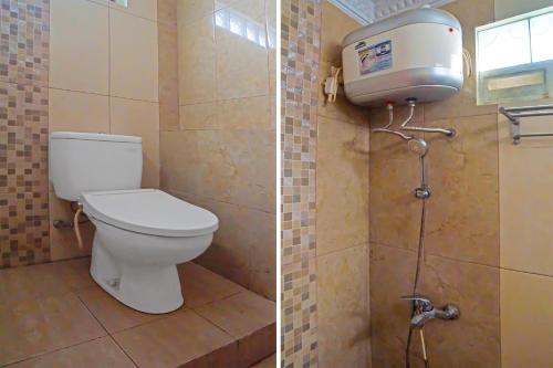 a bathroom with a toilet and a water tank at OYO 92314 De Coco Guesthouse in Medan