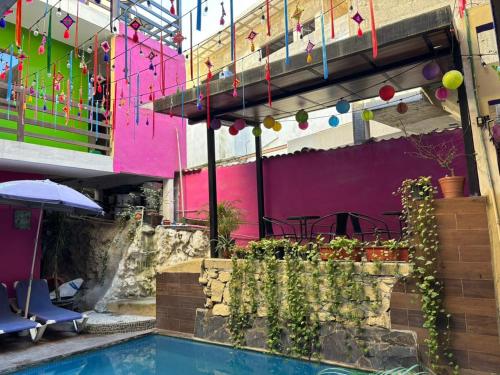 a swimming pool in front of a building with colorful walls at Playa Sayulita in Sayulita