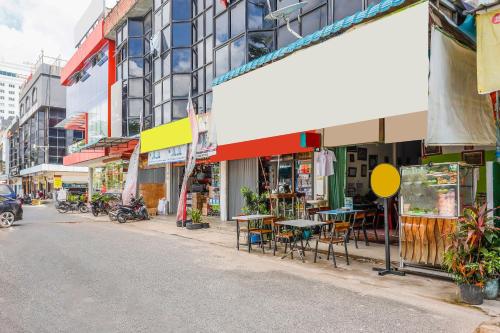 a city street with tables and chairs on the side of the road at Hotel O Wr House Syariah BatamNearEast Coast Park in Jodoh
