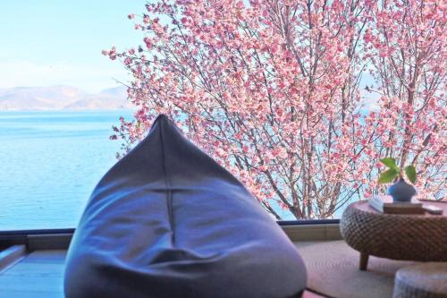 a couch in front of a window with a view of the water at Dali Beauty Seaview B&B in Dali