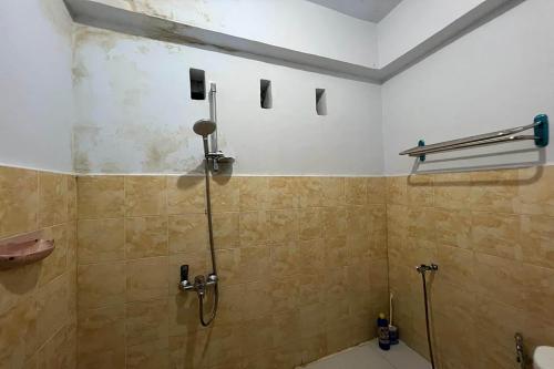 uma casa de banho com um chuveiro e uma porta de vidro em OYO 91757 Surya Hotel em Watansopeng