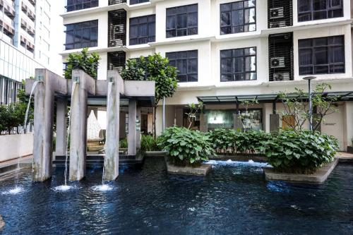a water fountain in front of a building at 188 Suites KLCC By Bliss Home At City Centre in Kuala Lumpur