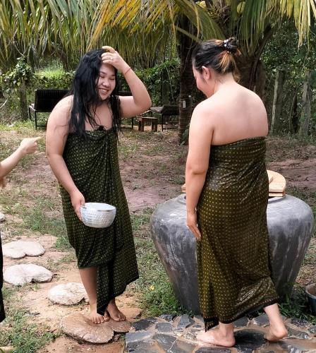 two women standing next to each other holding a bowl at Banteay Srey Women's Only Traditional Spa and Homestay in Kampot