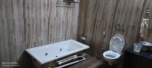 a bathroom with a sink and a toilet at Wild House Home stay in Jhirna