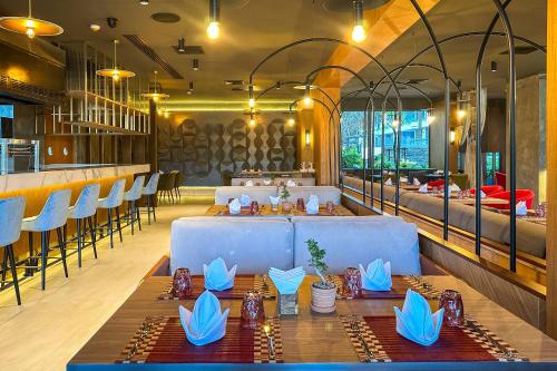 a restaurant with a long table and chairs at La Green Hotel and Residence in Bang Tao Beach