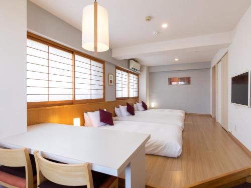 a room with four beds and a table and chairs at Tokyu Stay Monzen-Nakacho Tokyo in Tokyo