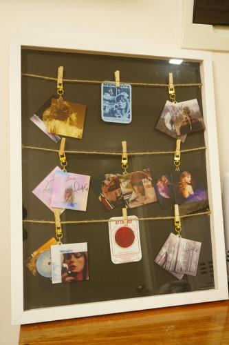 a display case with pictures and cards on a wall at Staycation in Marilao Bulacan Near Ph Arena - Swift Escape in Marilao