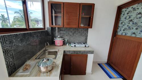 - une cuisine avec un évier et un comptoir dans l'établissement Nirmali Resort, à Mirissa