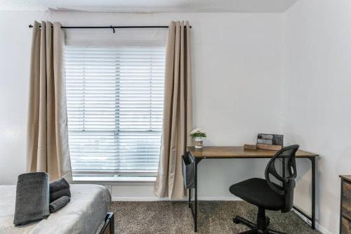 a bedroom with a desk and a chair and a window at Medical District_Fast Wi-fi in Dallas