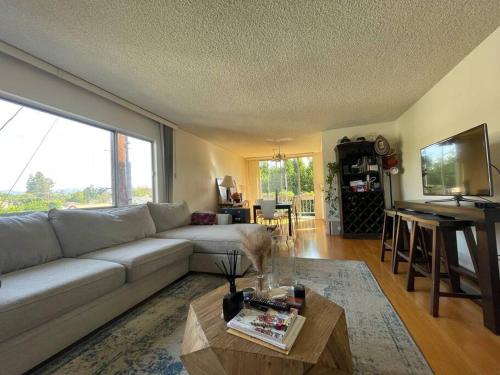 a living room with a couch and a table at Charming and Bright Apartment in Los Angeles