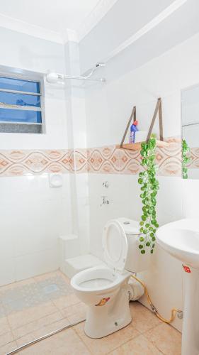 a bathroom with a toilet and a sink at Maya Homes in Naivasha