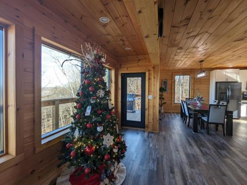 a christmas tree in a room with a dining room at Smoky Lake Retreat cabin in Dandridge