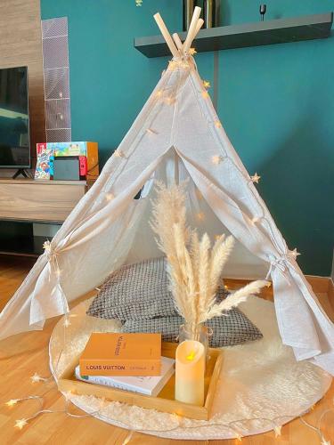 a tent with books and a candle on a table at imperium residence kuantan in Kuantan