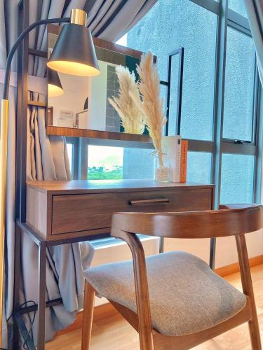 a desk with a chair in front of a window at imperium residence kuantan in Kuantan