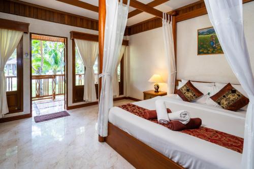 Ένα ή περισσότερα κρεβάτια σε δωμάτιο στο Long Beach Lodge, Chaweng Beach, Koh Samui