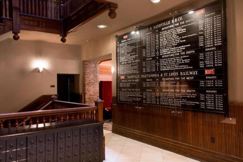 a restaurant with a large menu on the wall at The Union Station Nashville Yards, Autograph Collection in Nashville