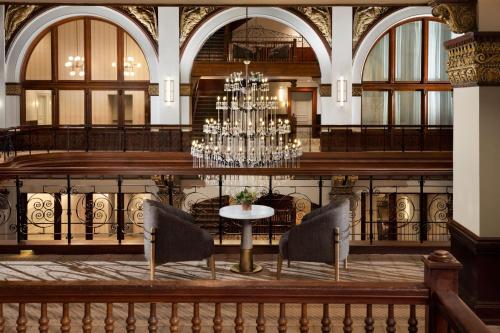 a dining room with a chandelier and a table at The Union Station Nashville Yards, Autograph Collection in Nashville