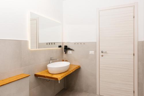 a bathroom with a sink and a mirror at La Casa di Ambra in Porto Torres