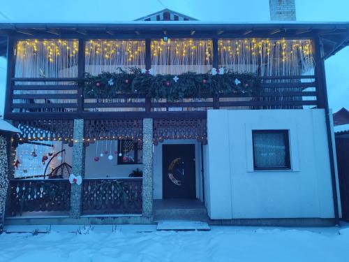 a house with christmas decorations on the porch at Карпатський куточок in Slavske