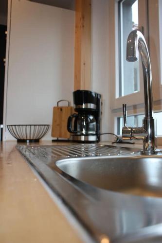 a kitchen counter top with a sink and a kitchen counter at Eifelhäusje Schäfer in Retterath