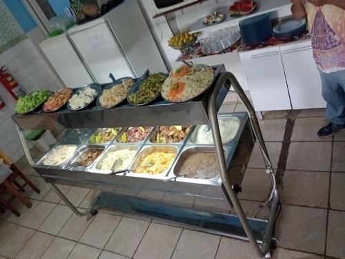 a display case filled with lots of different types of food at Hotel Frei Galvão in Aparecida