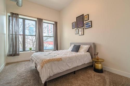 a bedroom with a bed and a large window at McCormick Place 420 friendly 3BR/2BA with Optional parking for up to 8 guests in Chicago