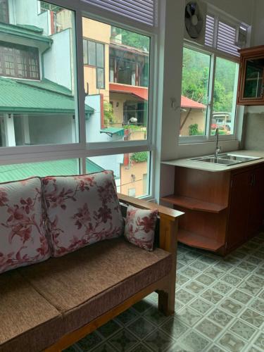 a couch in a room with a large window at Luxury apartment The Walkers Nest in Kandy