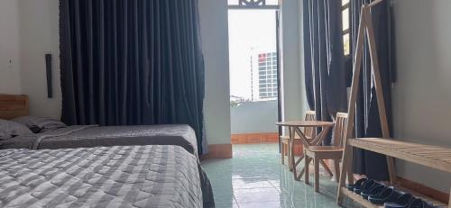 a hotel room with two beds and a window at Hotel Minh Vy in Long Hai