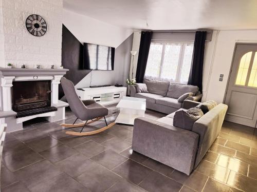 a living room with a couch and a fireplace at La Portel'Heurt in Le Portel