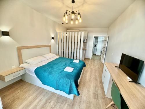 Schlafzimmer mit einem Bett und einem Flachbild-TV in der Unterkunft Apartment for you in Iwano-Frankiwsk