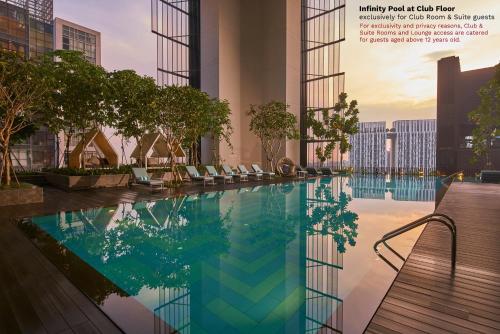 a rendering of a swimming pool in a building at Oasia Hotel Downtown, Singapore by Far East Hospitality in Singapore