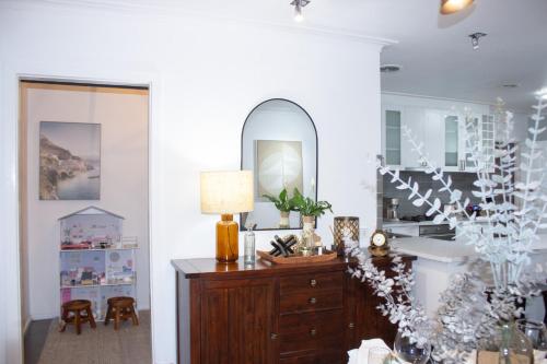 a living room with a dresser and a mirror at Ballarat Cozy Cottage for Families, Sleeps 8, Pet Friendly, Big backyard, Parking for 4 cars, Close to Shopping mall in Ballarat