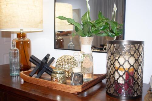a table with a vase and a plant on it at Ballarat Cozy Cottage for Families, Sleeps 8, Pet Friendly, Big backyard, Parking for 4 cars, Close to Shopping mall in Ballarat