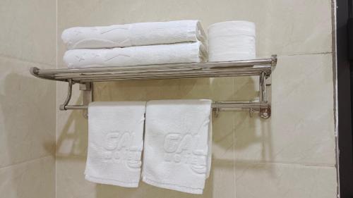 a towel rack with towels on it in a bathroom at Galaxy Grand Hotel in Sơn La