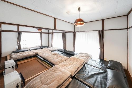 a large room with two large beds in it at ガチンコBBQロッジ北軽井沢 in Tsumagoi