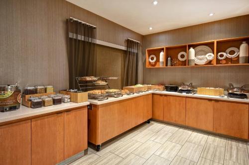 a buffet line in a restaurant with food at SpringHill Suites by Marriott Atlanta Kennesaw in Kennesaw