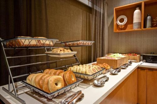 a buffet line with different types of bread on display at SpringHill Suites by Marriott Atlanta Kennesaw in Kennesaw